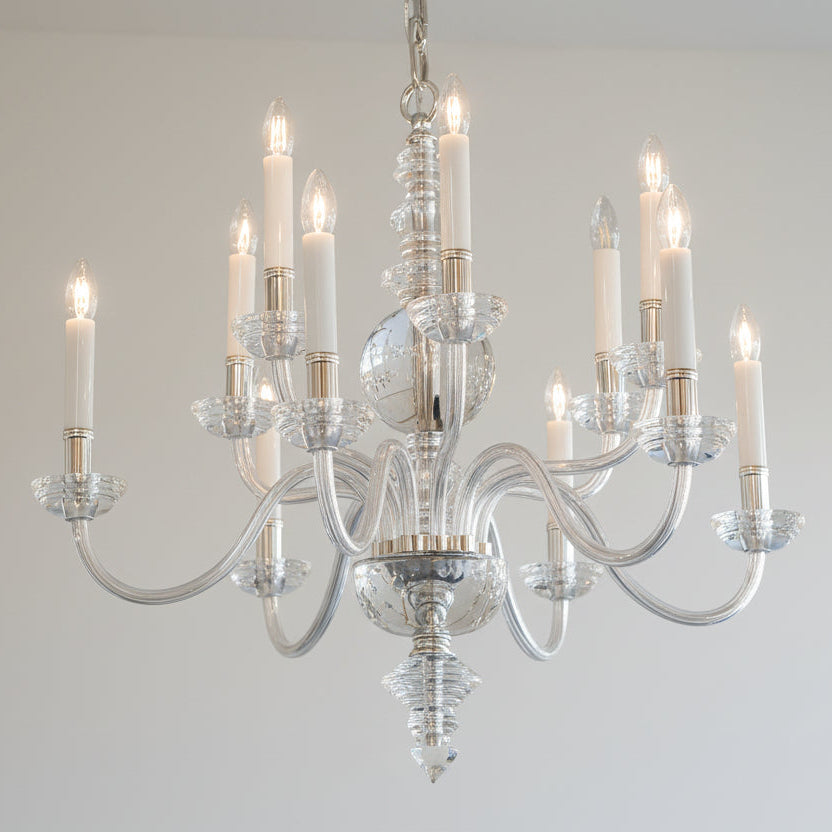 Chandelier with clear glass and metal design on a plain background