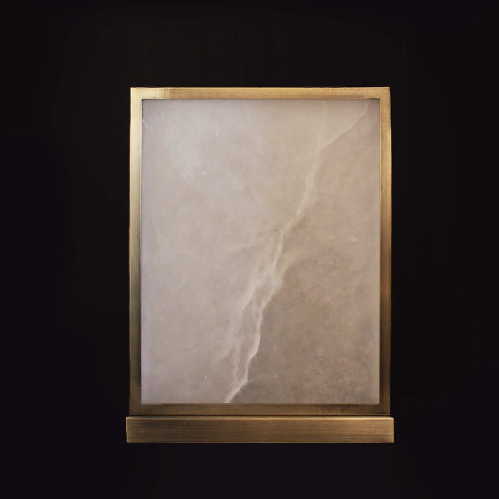 Decorative stone table lamp on a black background