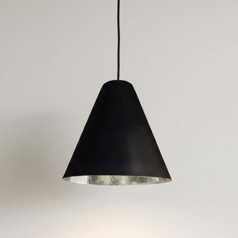 Bar counter with black and silver pendants in a dimly lit bar setting