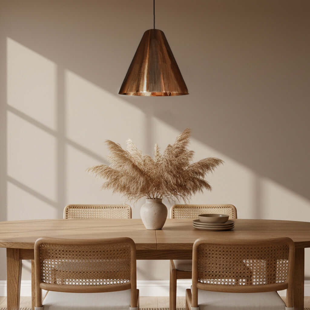 Dining room with wooden table, wicker chairs, and a copper pendant light.