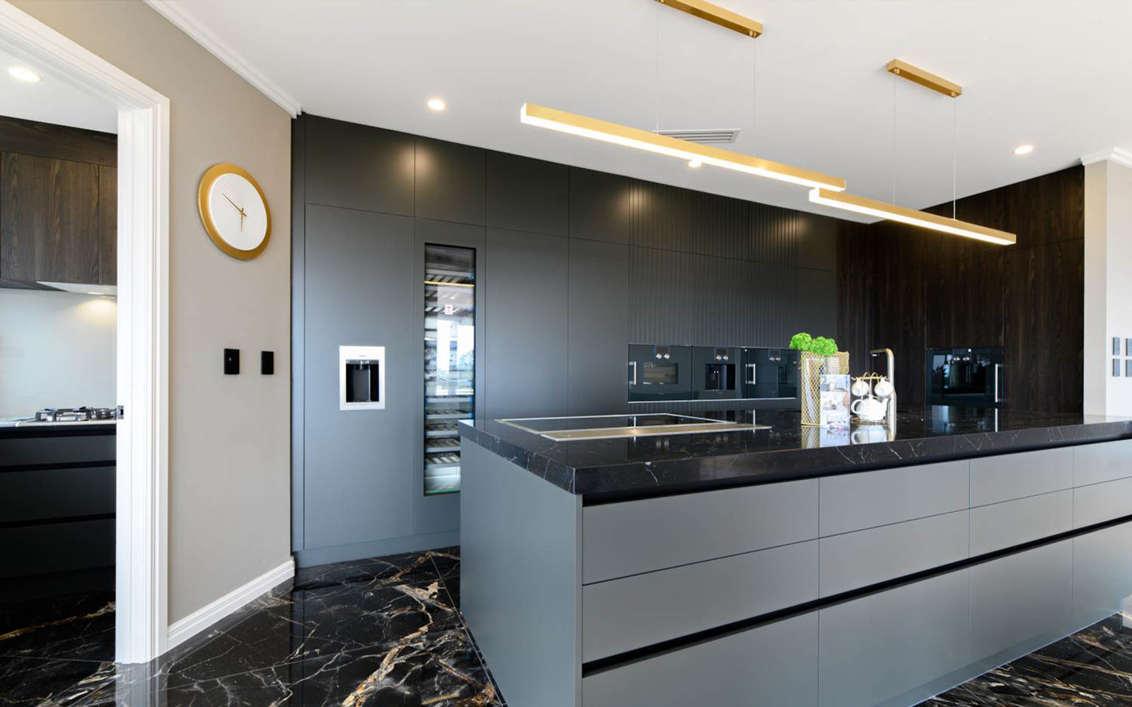 Linear Alinea Brass LED pendant light over contemporary kitchen Murano Plus lighting