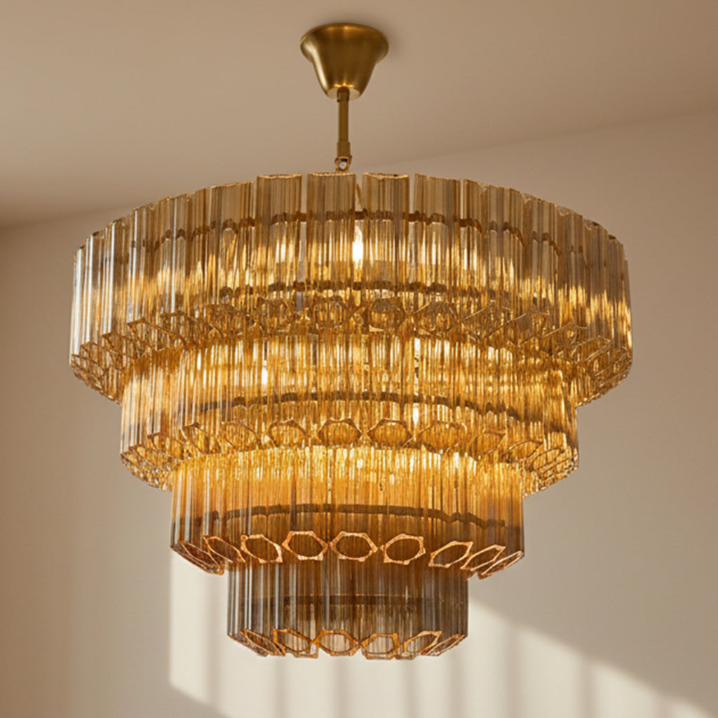 Gold chandelier hanging against a beige wall
