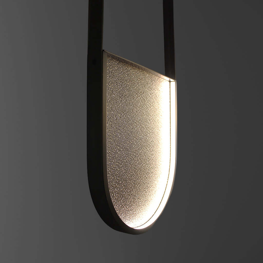 Modern pendant light with a textured shade on a dark background