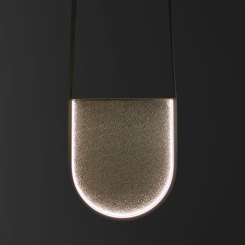 Metal and glass pendant light on a black background