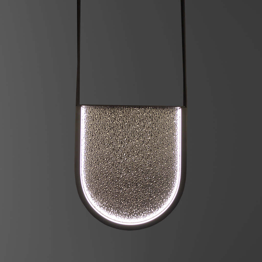 Close-up of a textured glass pendant light on a dark background