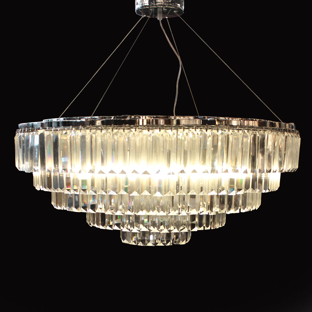 Tiered chandelier with hanging clear prism crystals and chrome frame on a black background