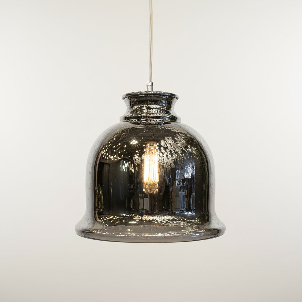 Hanging glass lantern with plants in the background