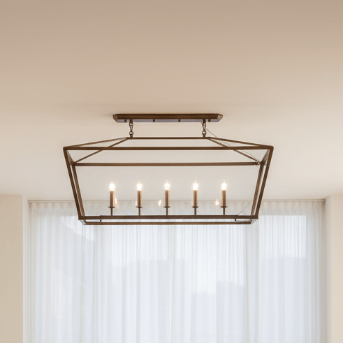 Decorative ceiling light fixture in a room with white curtains