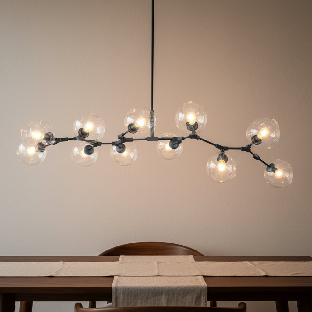 Modern chandelier with multiple light bulbs hanging above a dining table.
