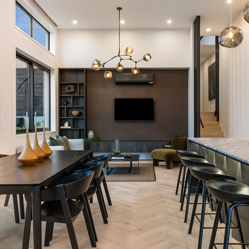 Modern living room with a dining table, chairs, and a bar area.