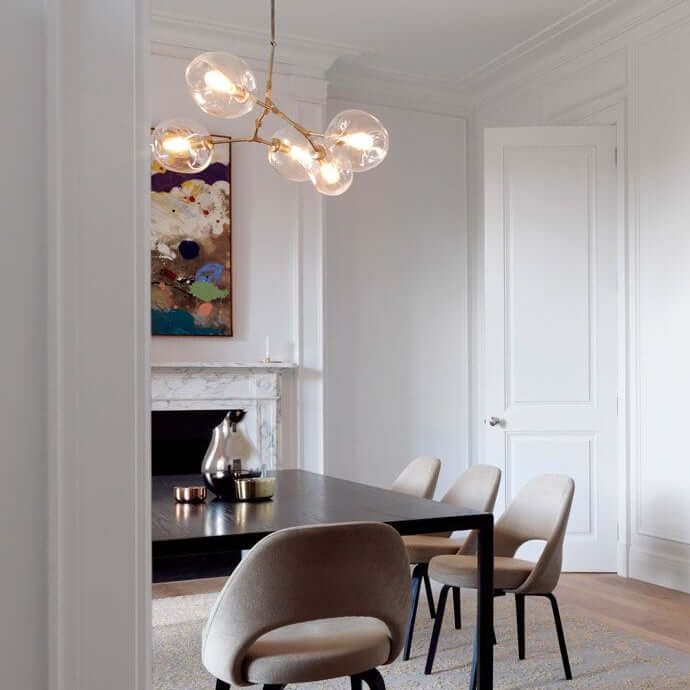 Modern chandelier with glass circular shades on a white background
