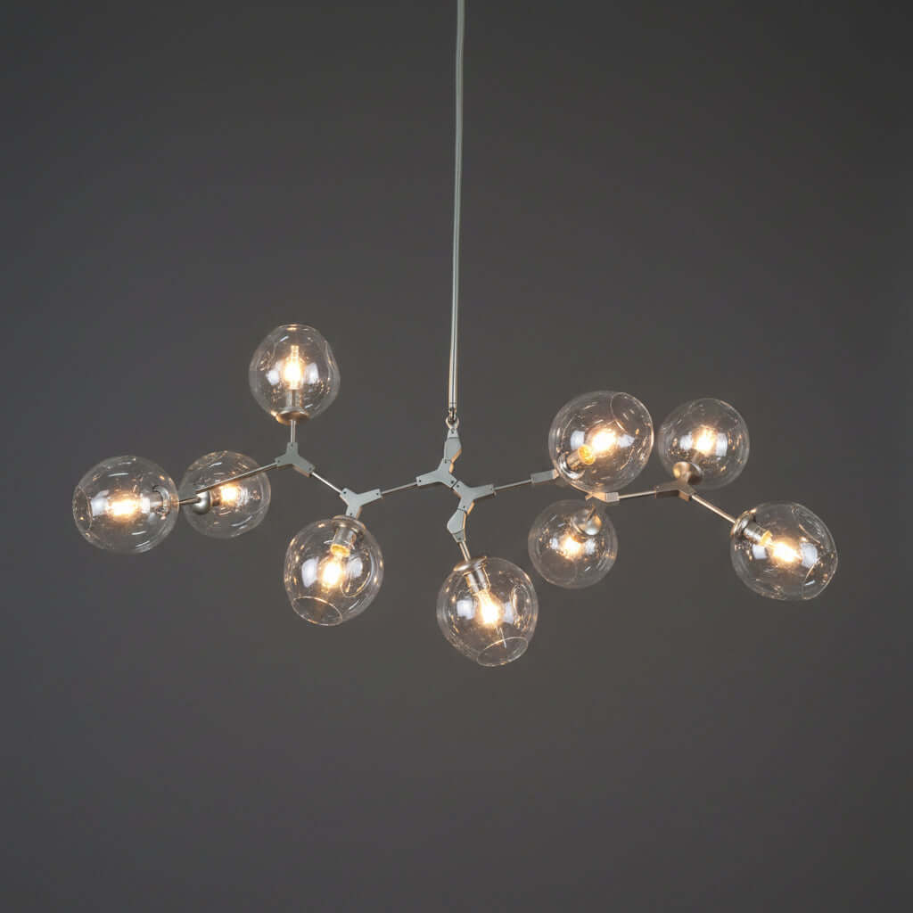 Modern chandelier with multiple glass bulb shades on a white background