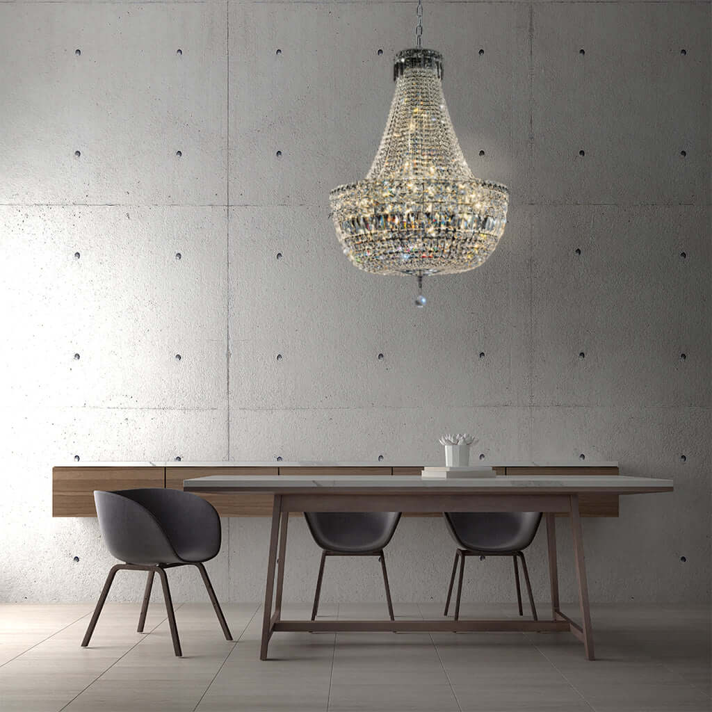 Dining area with a chandelier, table, and chairs against a concrete wall.