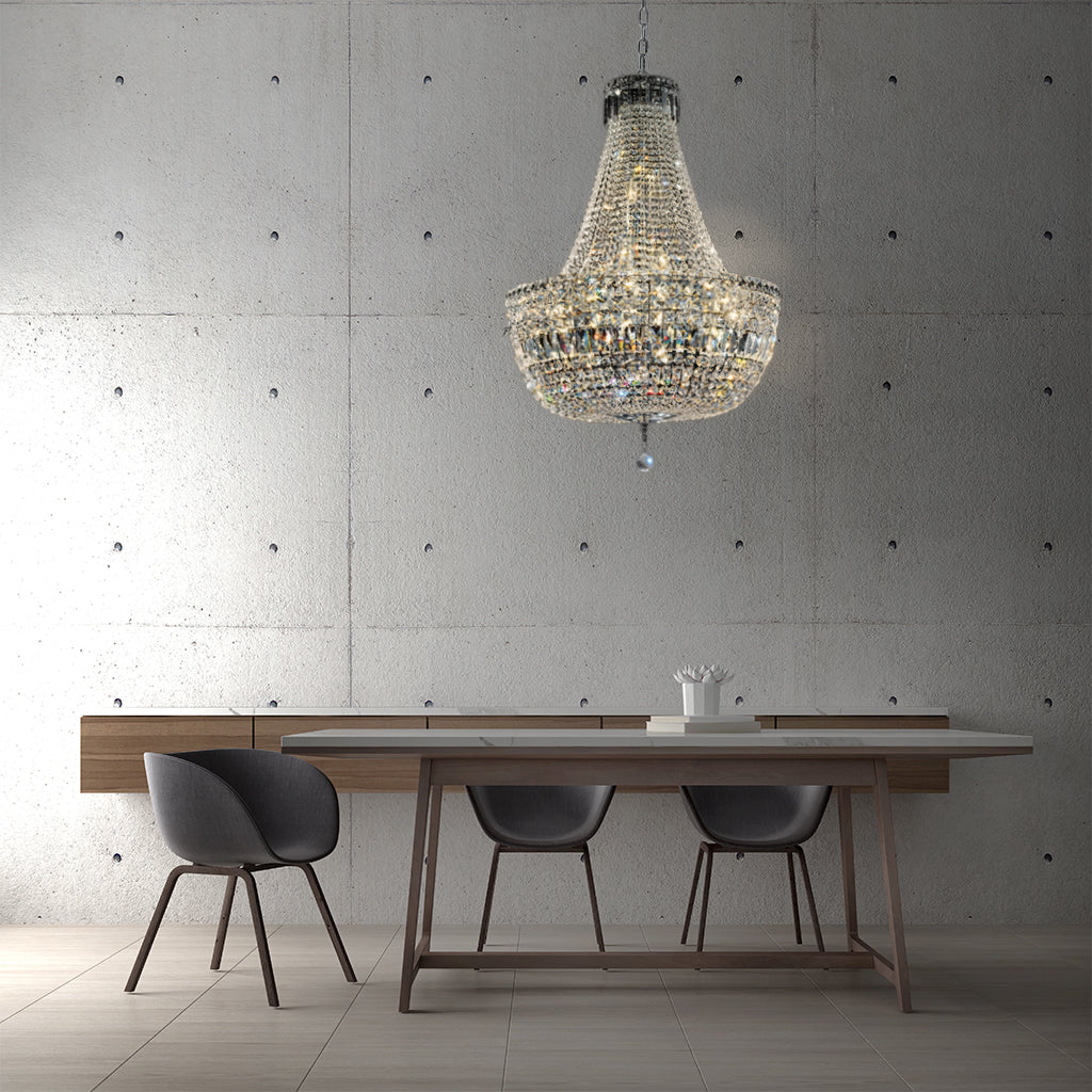 Dining area with a chandelier, table, and chairs against a concrete wall.