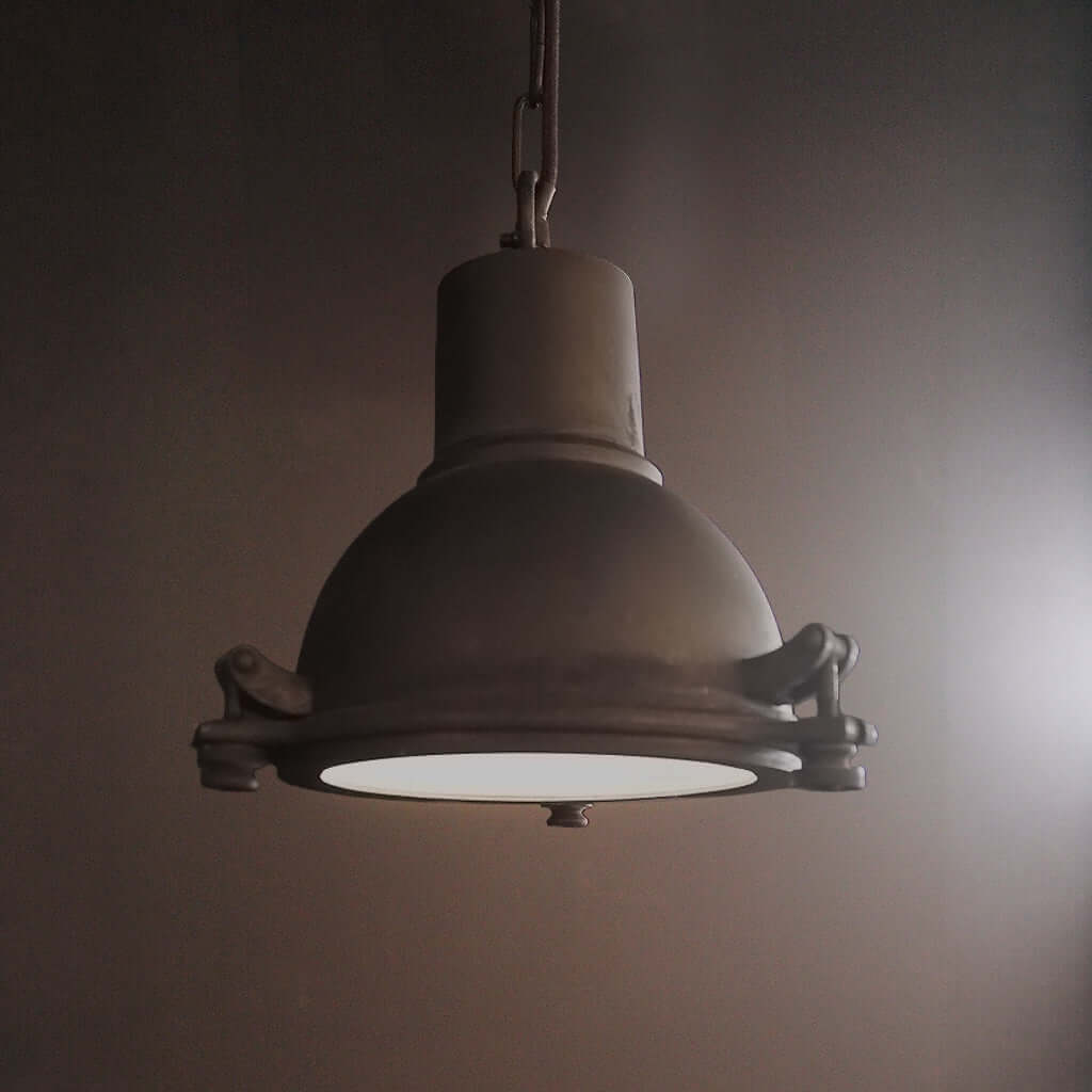 Vintage-style pendant light hanging against a plain background