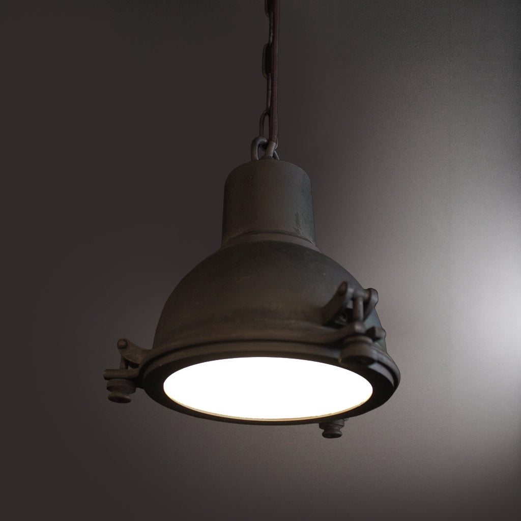 Vintage-style pendant light with a dark gray finish on a plain background