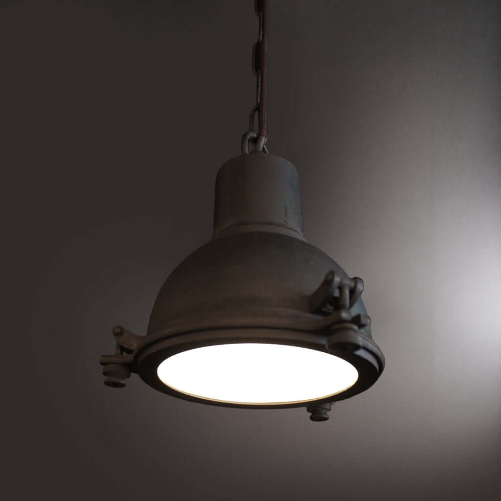 Vintage-style pendant light with a dark gray finish on a plain background