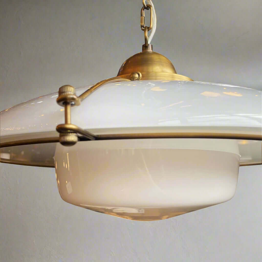 Antique brass finish pendant light with a handmade gloss white glass shade, featuring a 450mm diameter and 270mm height with a suspension chain.