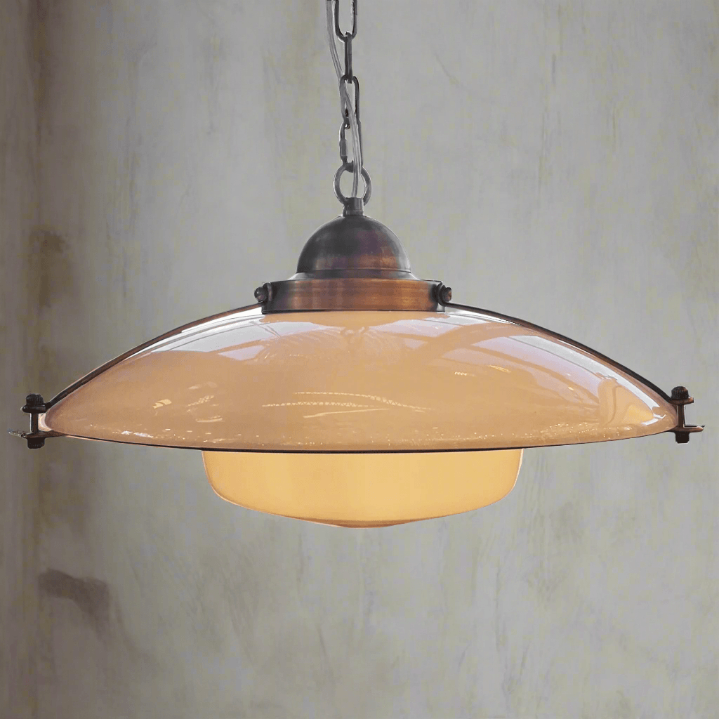 Vintage-style pendant light with beige shade against a textured wall.