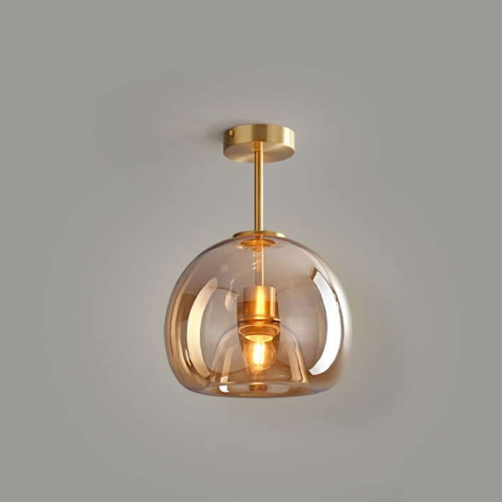 A Deon ceiling light with a tinted amber glass shade and brass fittings