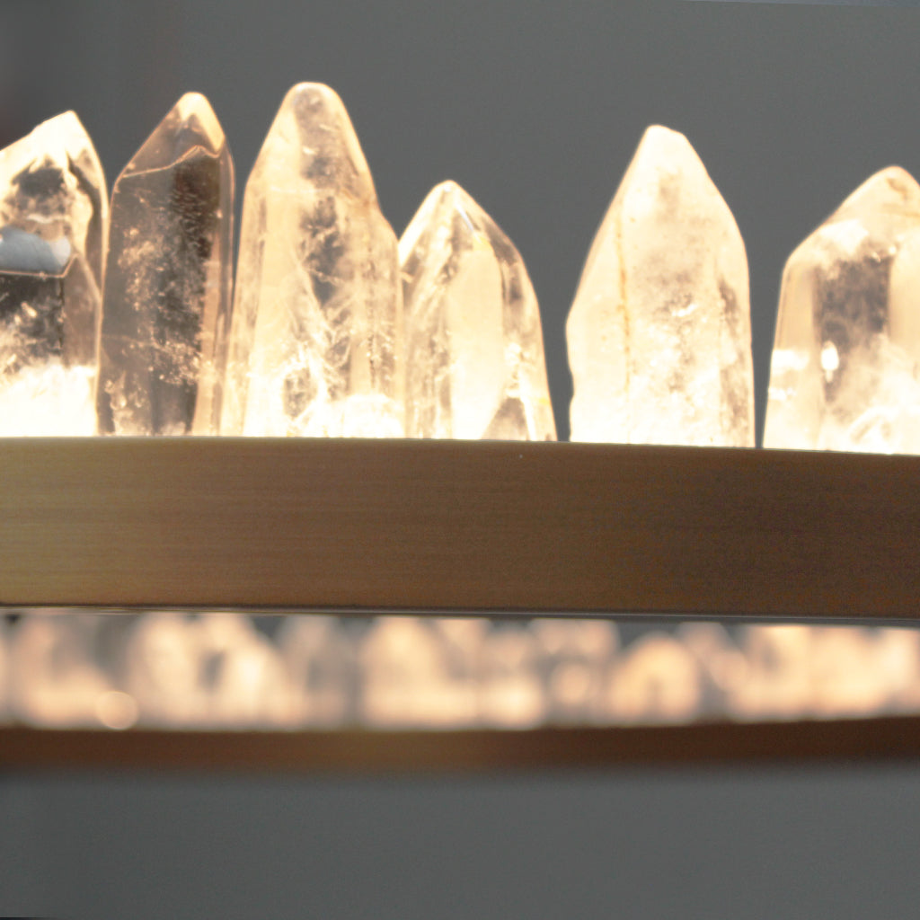 Close-up of crystal points on a Brass pendand against a dark background