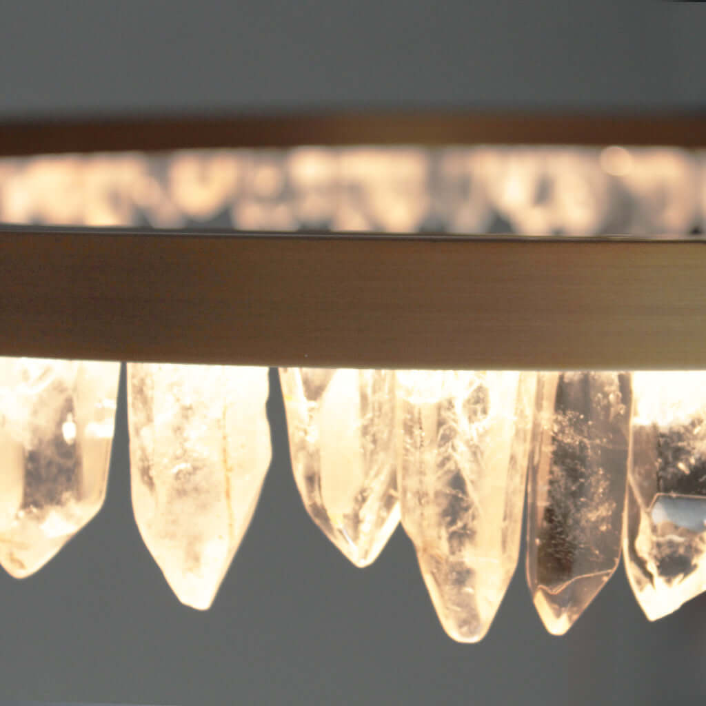 Close-up of crystal points on a Brass pendant against a dark background