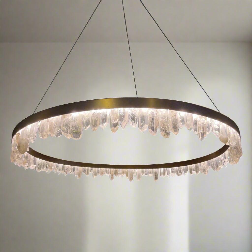 Antique Brass finished pendant light with natural crystals directed in various directions, suspended from the ceiling.