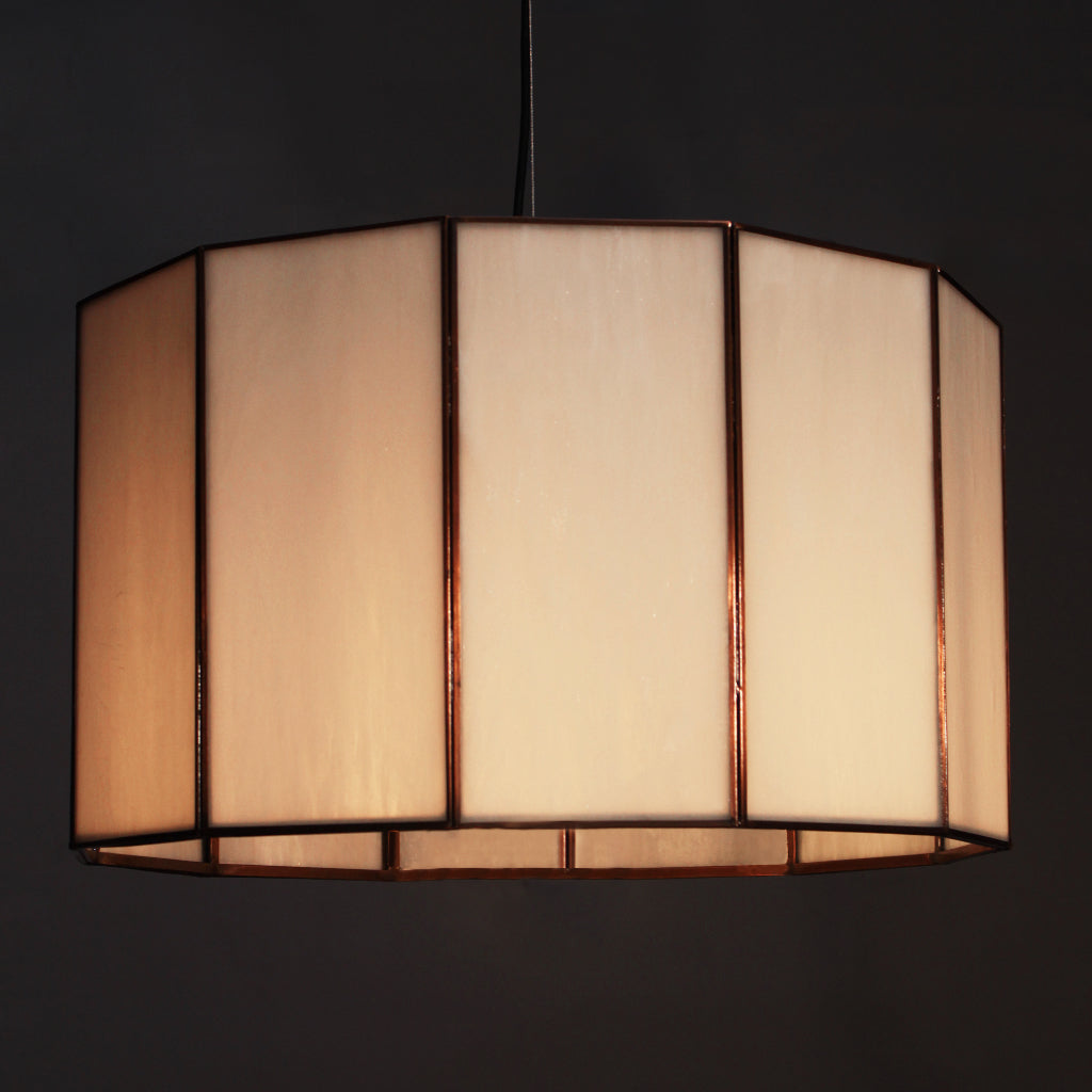 White glass lampshade with a dark frame on a black background