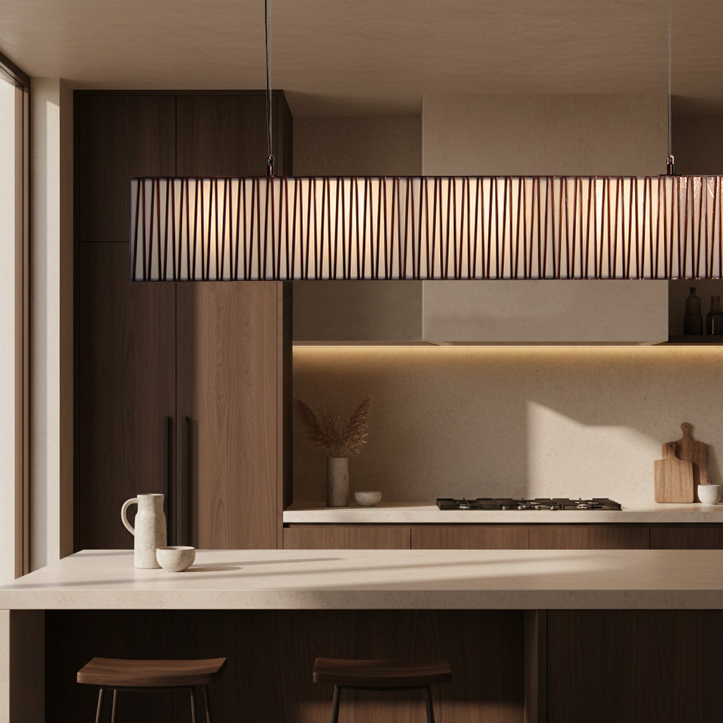 Modern kitchen with wooden cabinets, a pendant light, and a countertop.