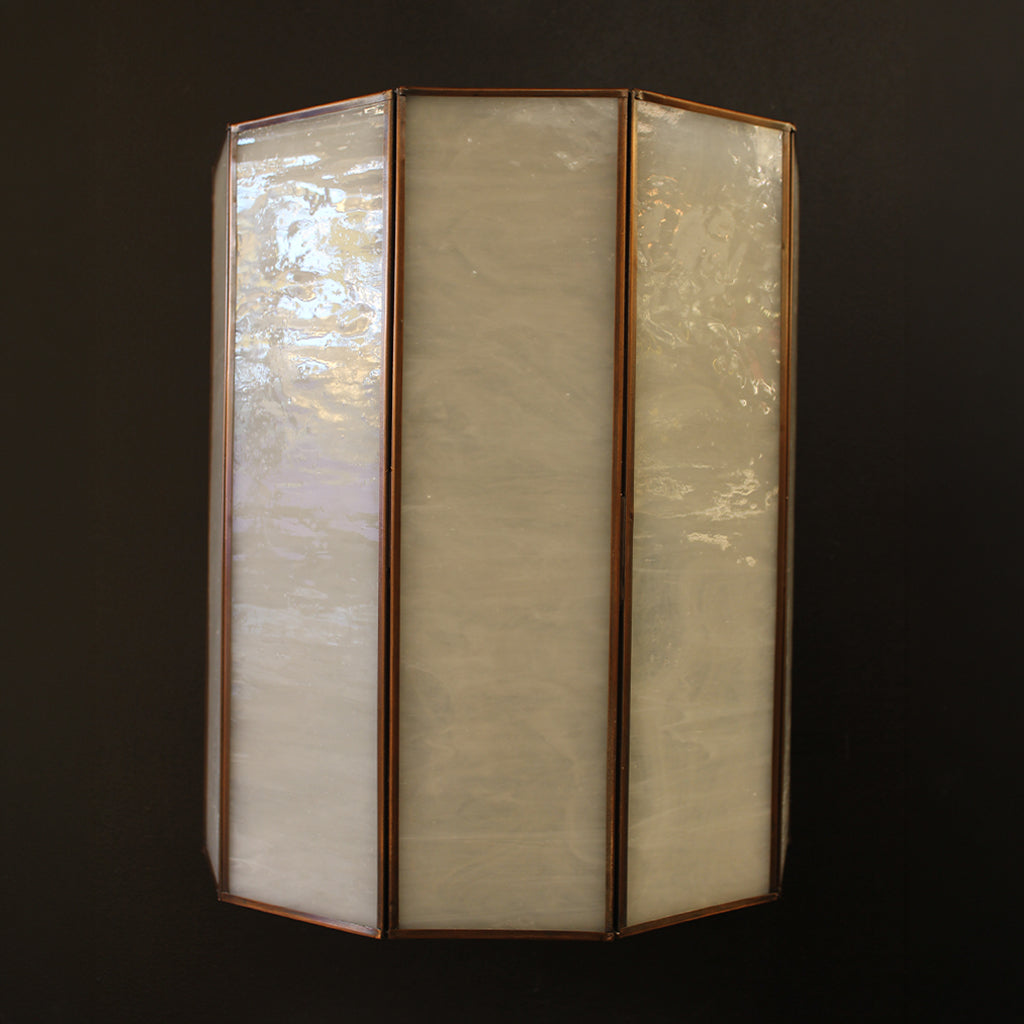 Tri-fold wall light fixture with glass panels on a dark background