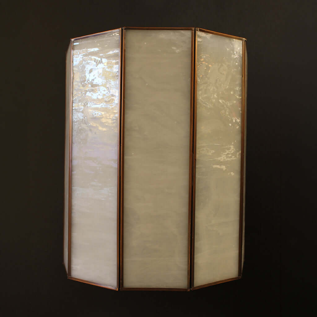 Tri-fold wall light fixture with glass panels on a dark background