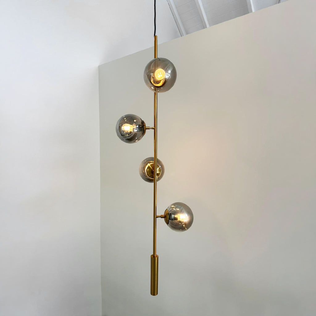 Vertical format pendant light in tall double height void space