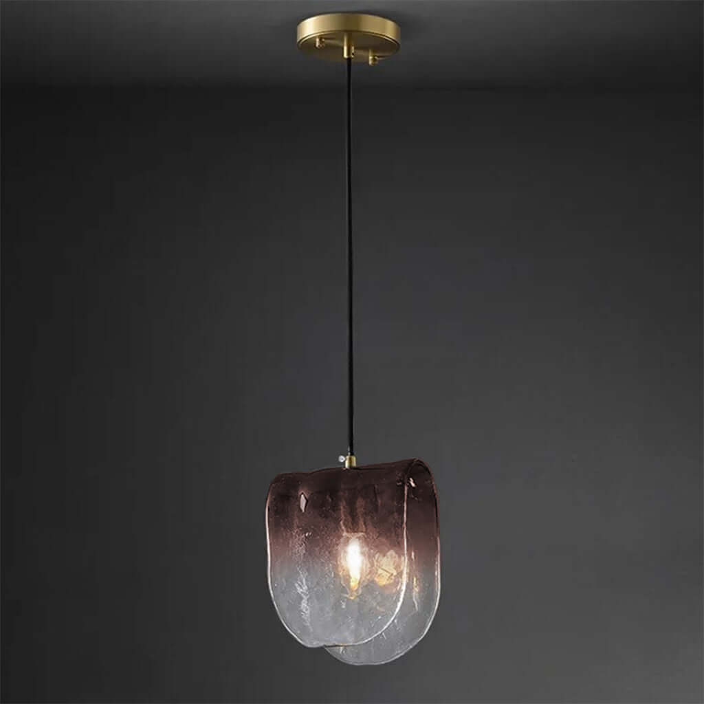 Modern pendant light with a glass shade on a dark background