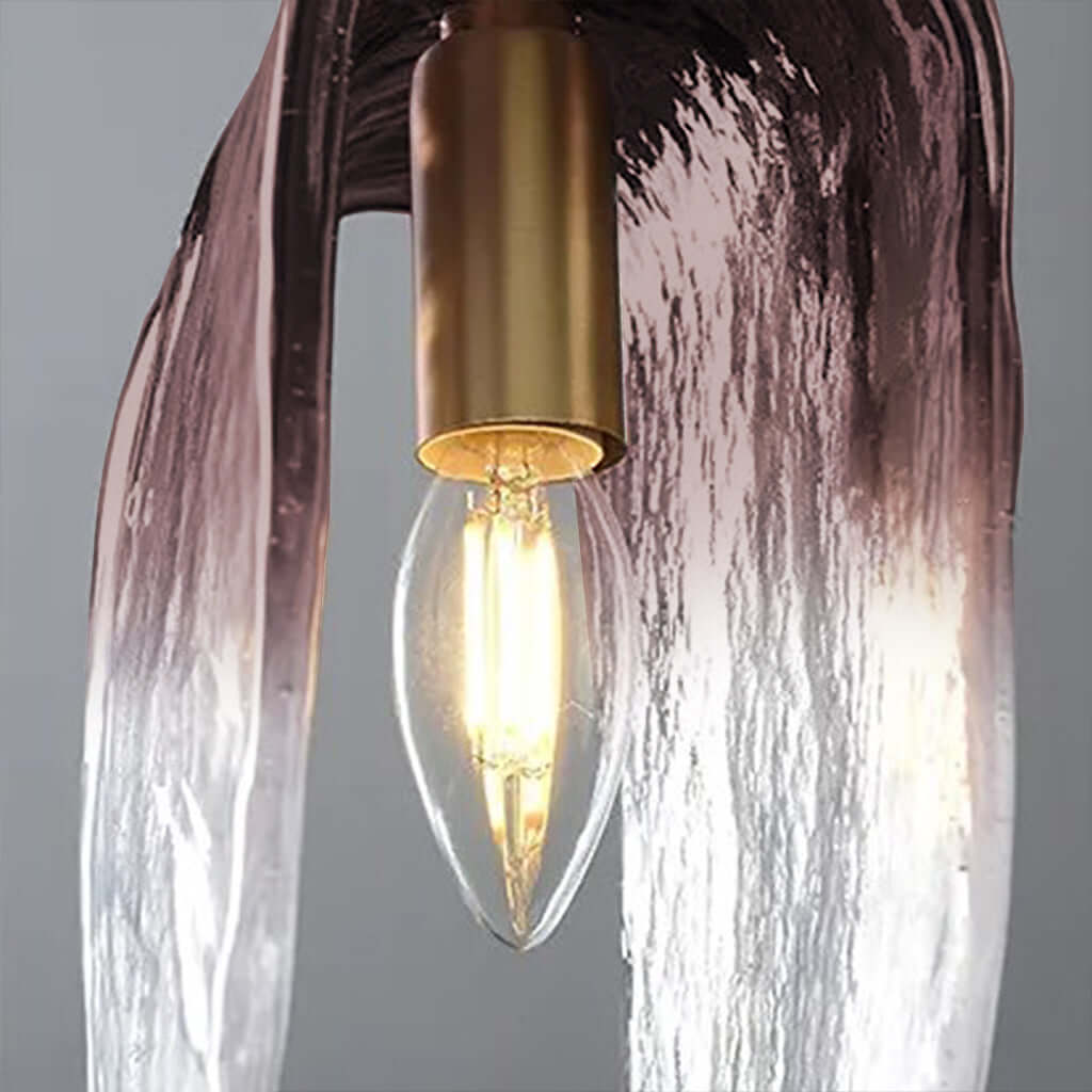 Light bulb inside a decorative lamp with a textured glass shade on a gray background