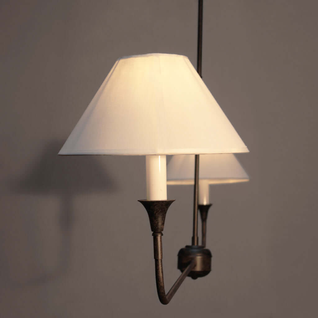 Modern pendant light with two lamps on a plain background