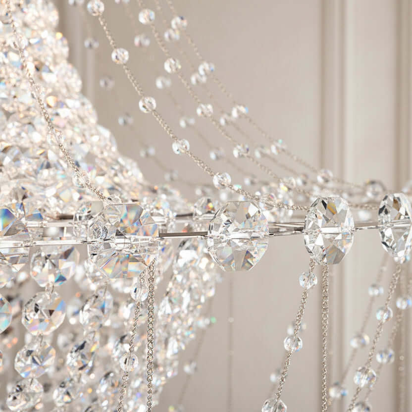 Close-up of a crystal chandelier with multiple strands of beads against a black background