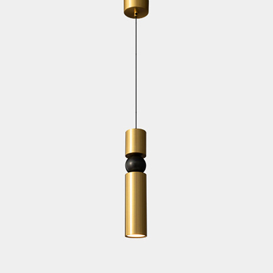 Gold pendant light with black accent on a white background