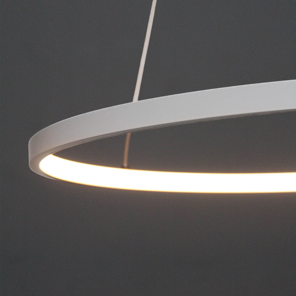 Modern pendant light with a white circular shade on a dark gray background