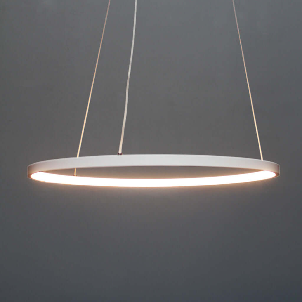 Modern pendant light with a white circular shade on a dark gray background