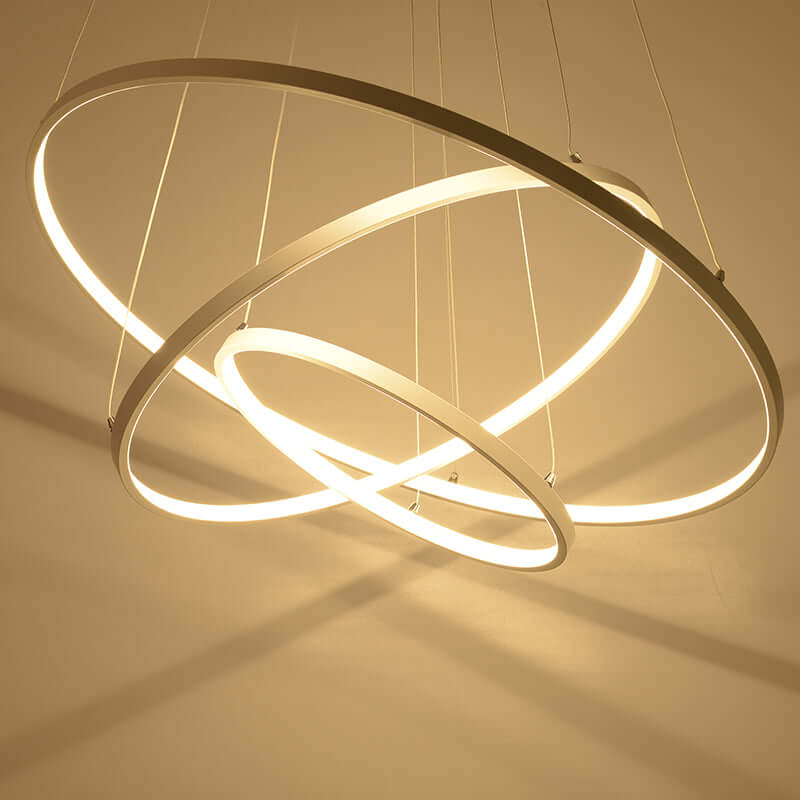 Modern chandelier with three interlocking rings on a beige background