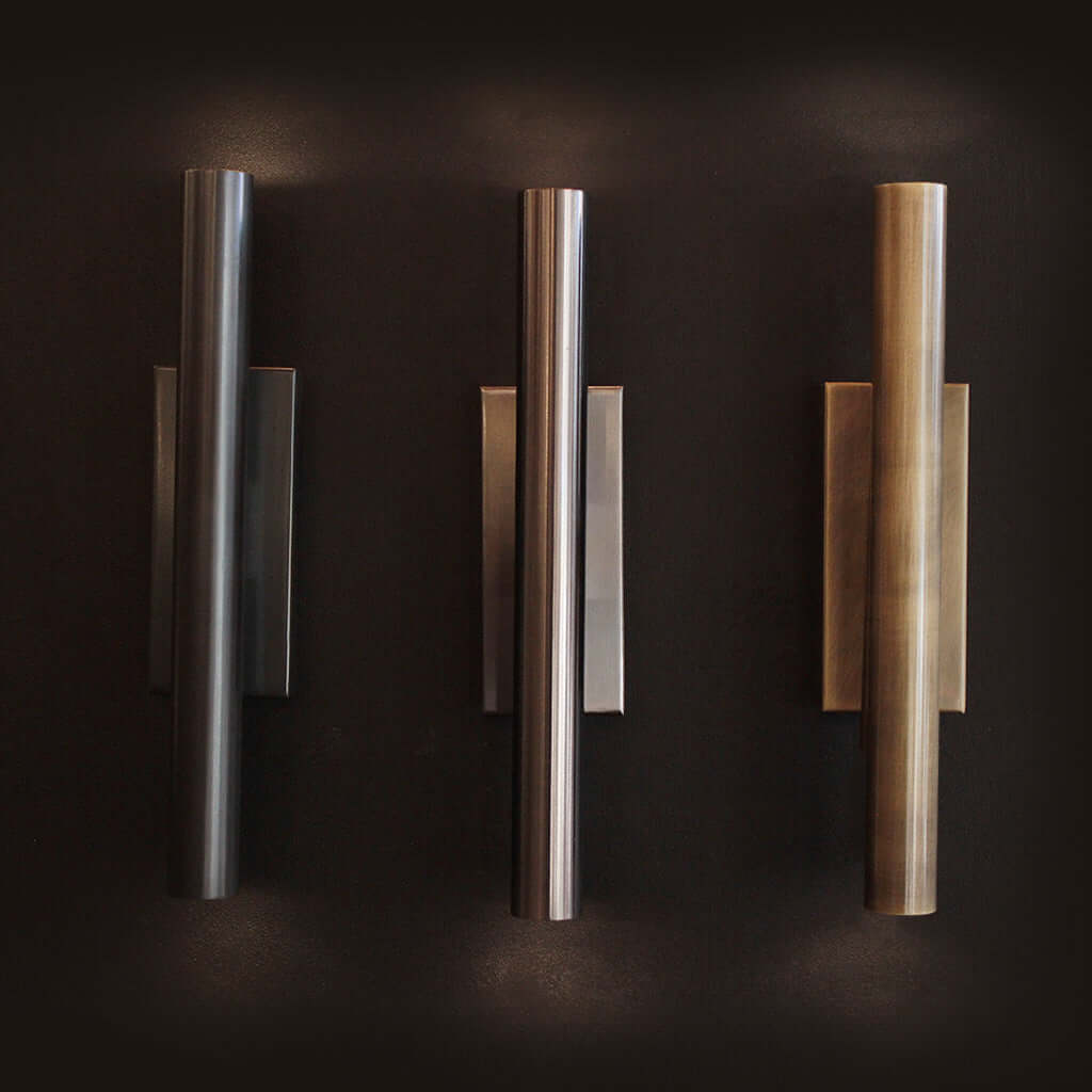 Three wall lights in varying finishes