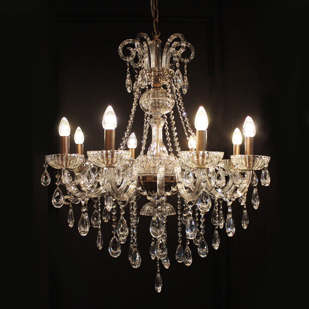 Crystal chandelier with multiple lights on a black background