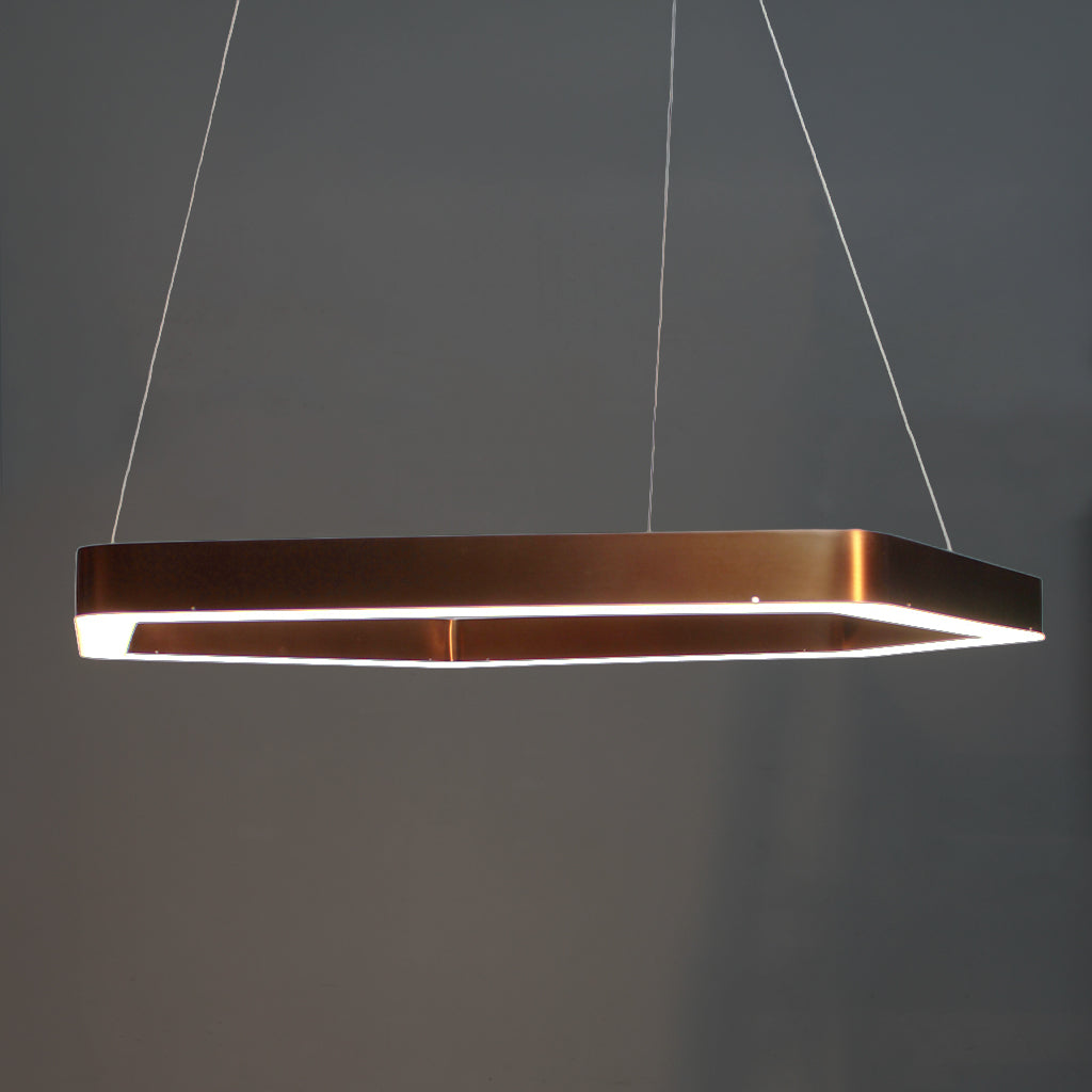 Modern pendant light with a copper finish on a dark background