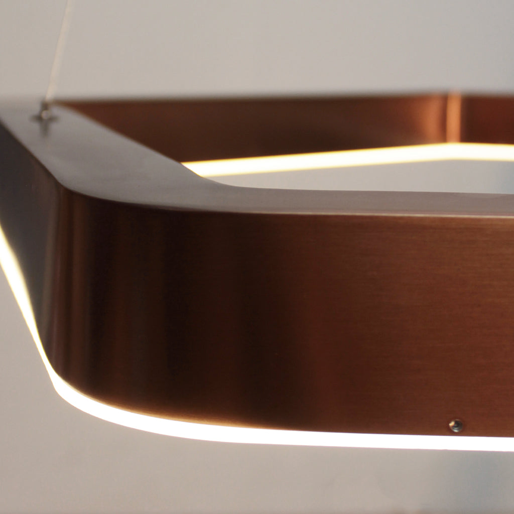 Close-up of a modern pendant light with a metallic finish.