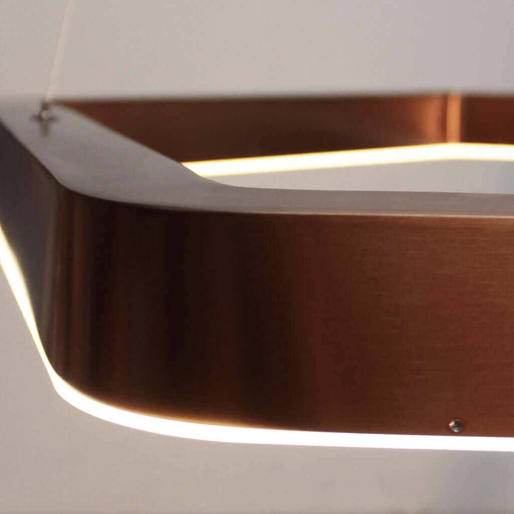 Close-up of a modern pendant light with a metallic finish.