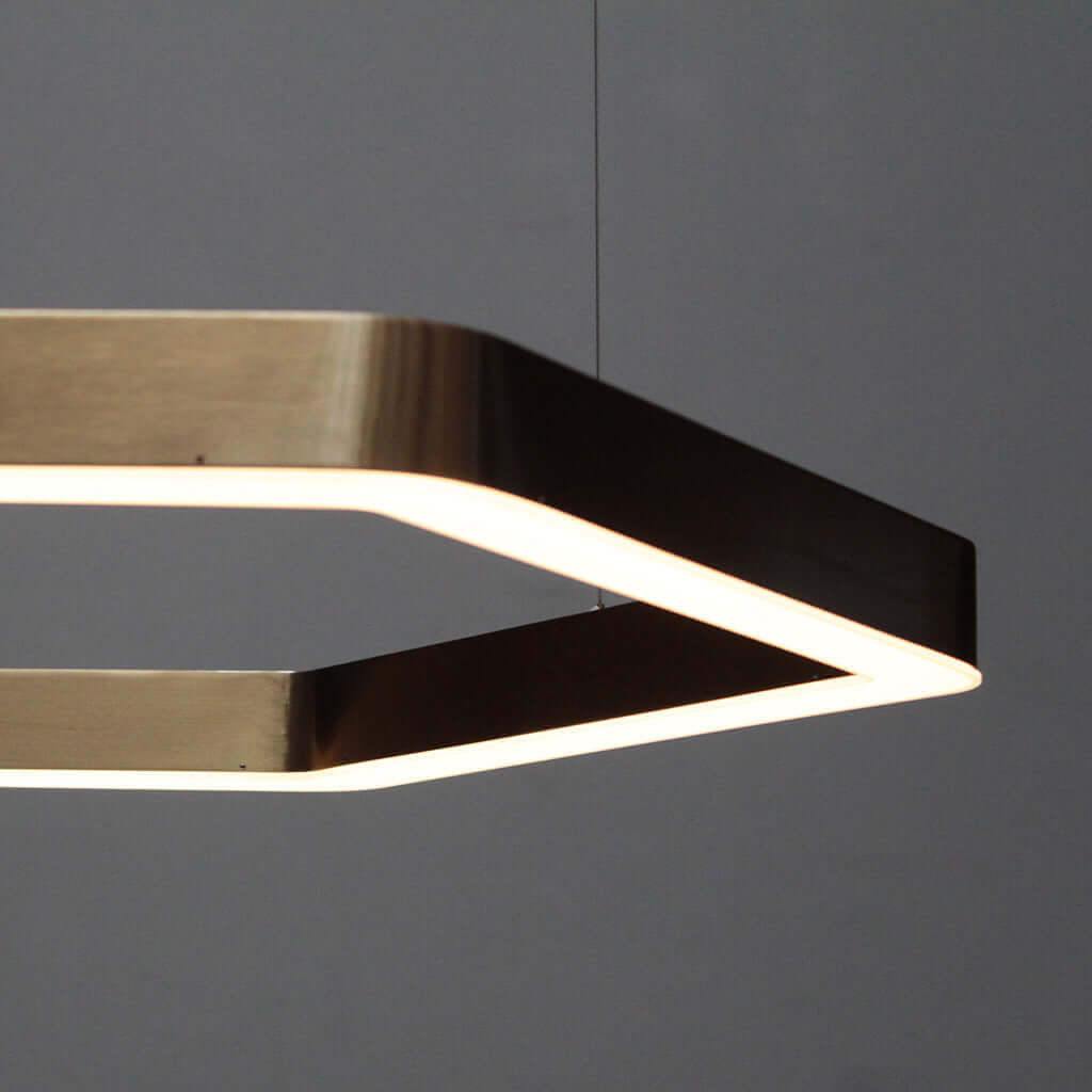 Modern pendant light with geometric design on a gray background