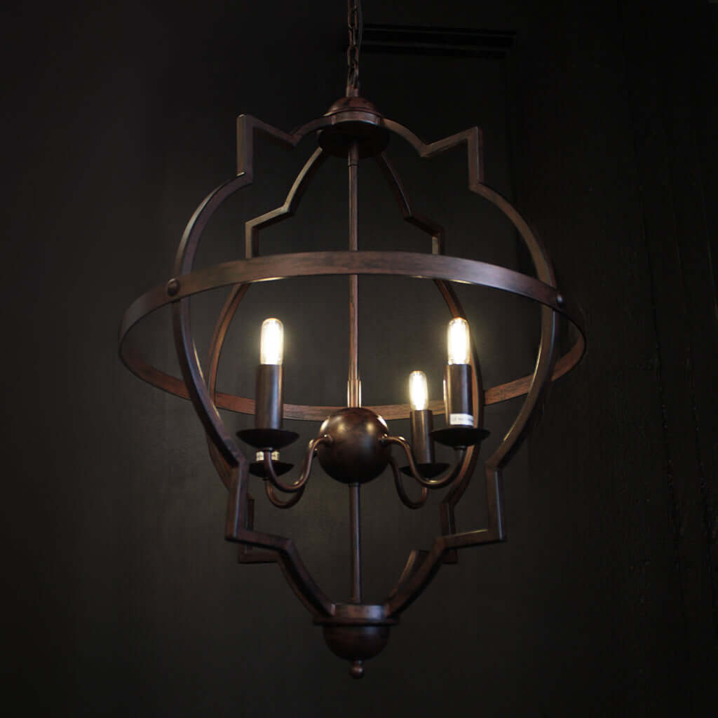 Decorative chandelier with three lit candles on a dark background