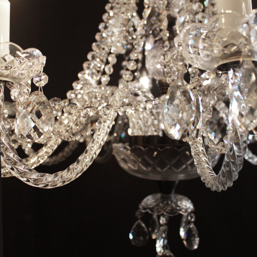Close-up of a crystal chandelier against a dark background