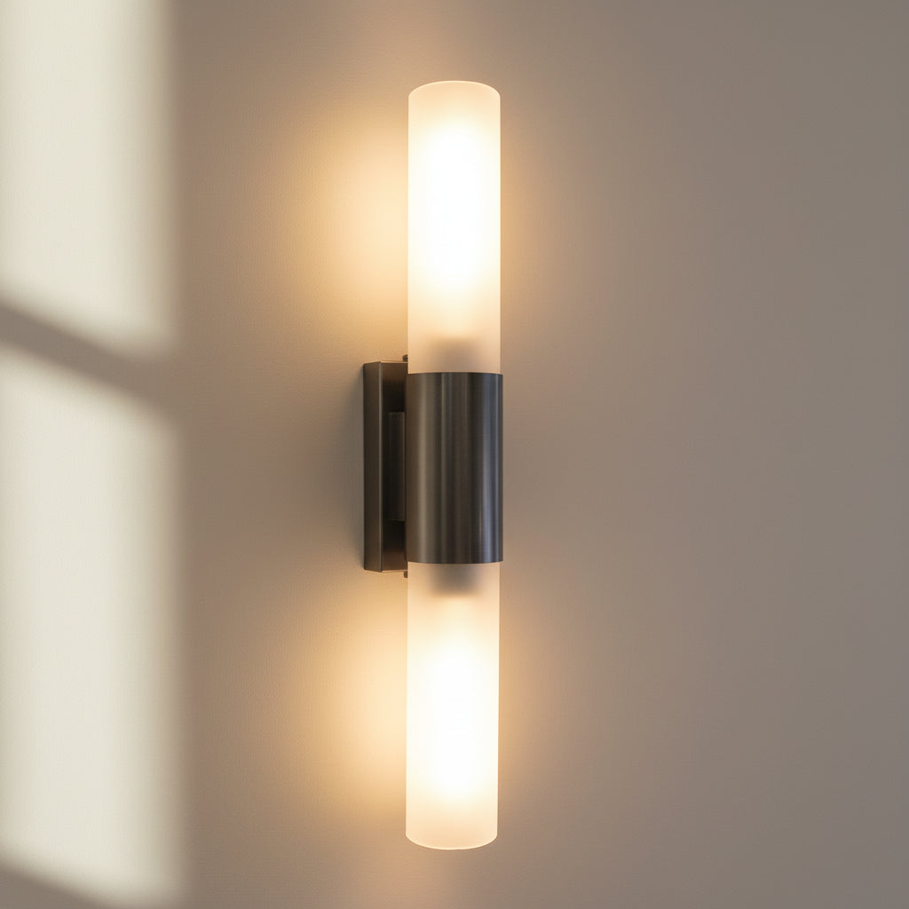 Wall-mounted light fixture with two illuminated cylindrical bulbs on a dark background