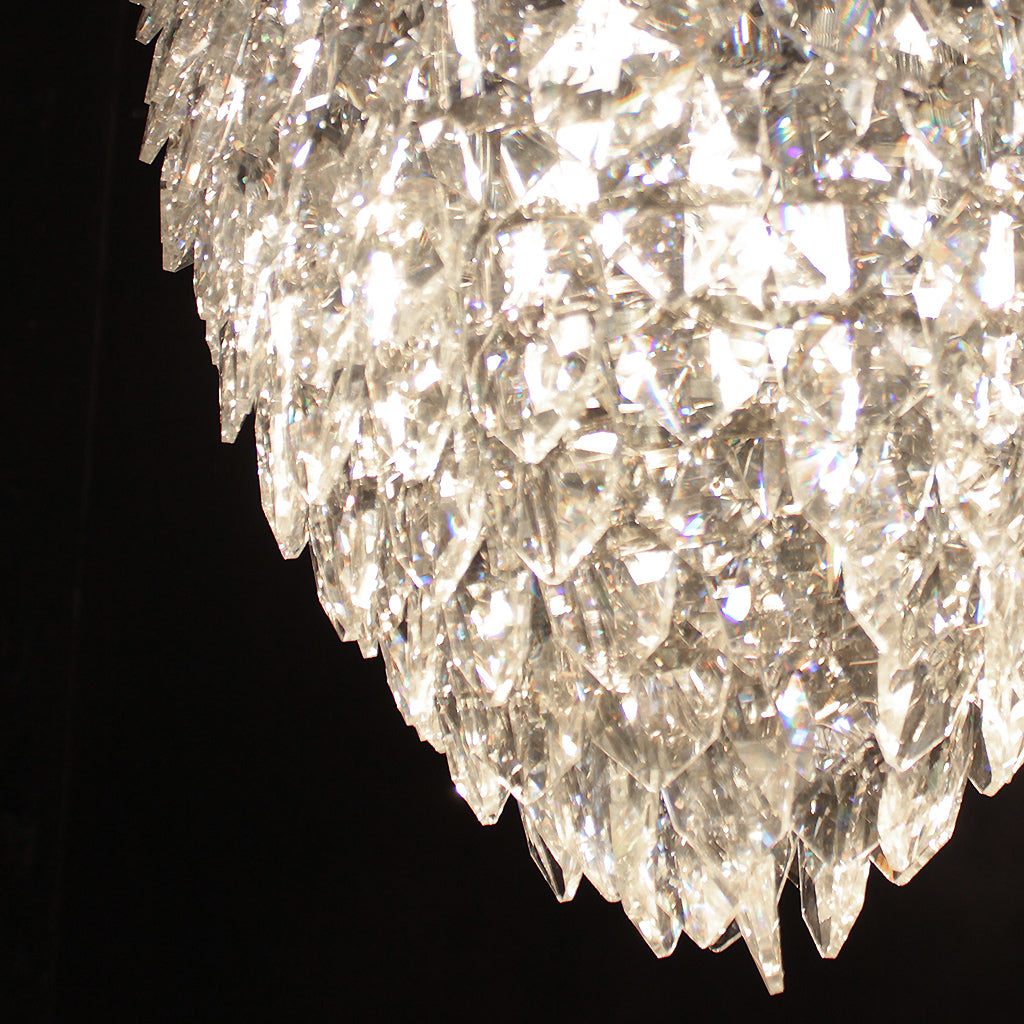 Close-up of a crystal chandelier against a black background